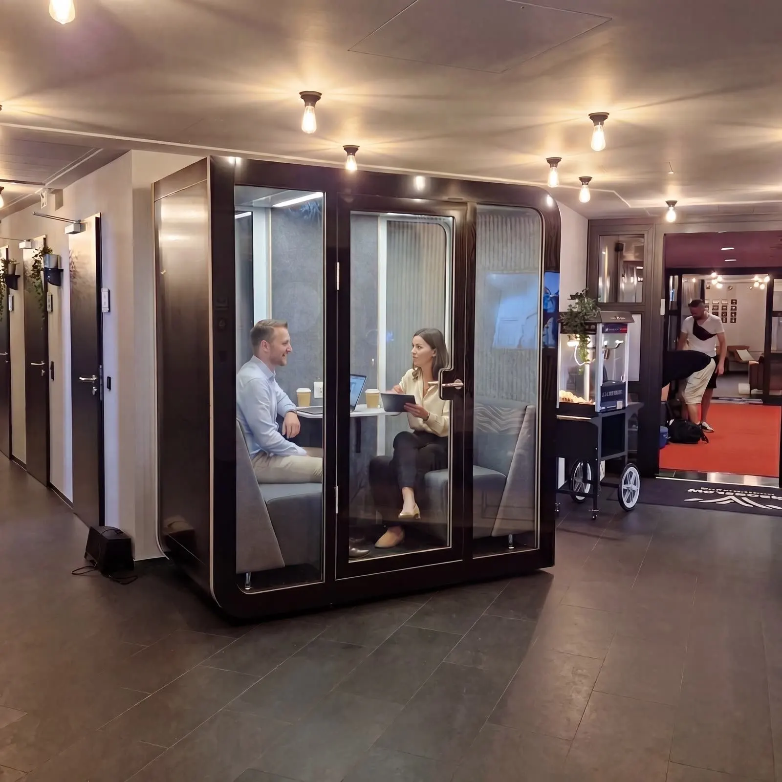 Silentbox Duet in use — two people meeting inside the booth in an office